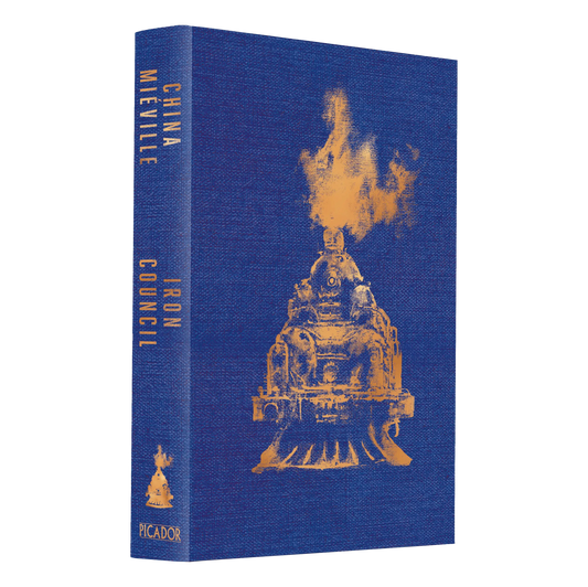 The book cover of "Iron Council" by China Miéville, featuring a textured blue background with an orange illustration of a train engine.