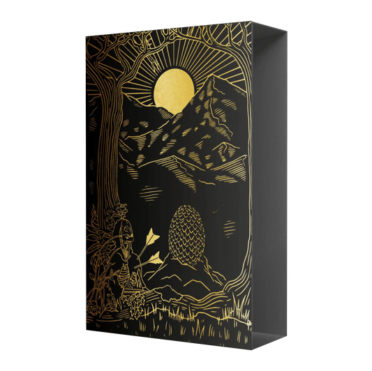 A black book with intricate golden illustrations of trees, mountains, the sun, figures and shapes resembling eggs.
