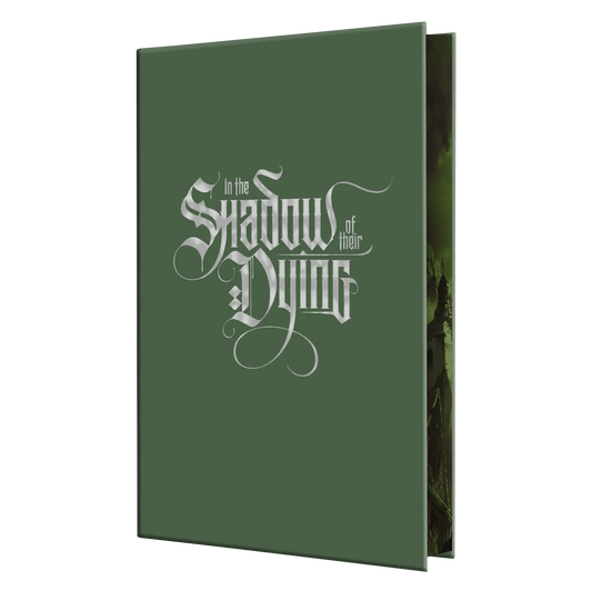 "In the Shadow of Their Dying" is a dark green book featuring an elaborate gothic font on the cover.
