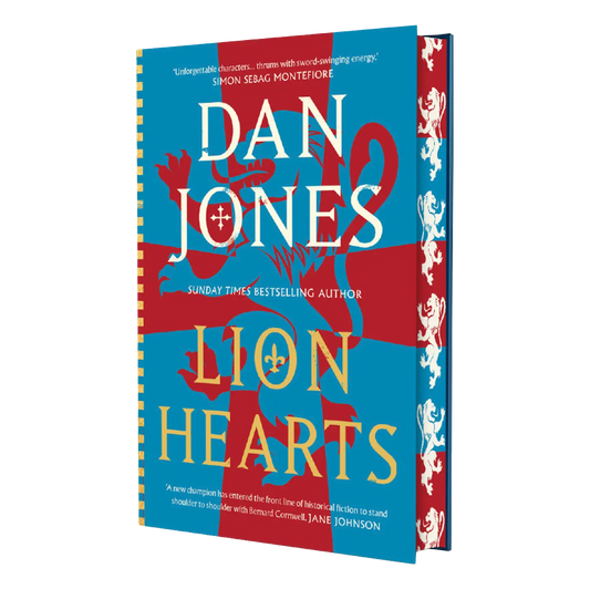 "Lion Hearts" by Dan Jones is a historical fiction book featuring a dynamic cover with red and blue designs and lion motifs.