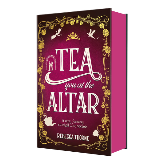 "Tea You at the Altar" by Rebecca Thorne is a cosy fantasy novel featuring an inviting burgundy cover with gold floral accents.
